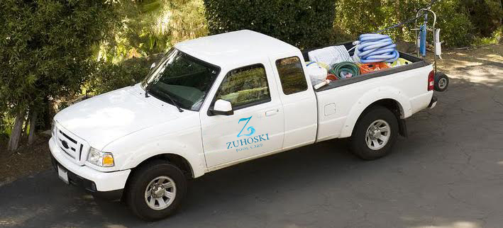 A white color truck with pool equipment